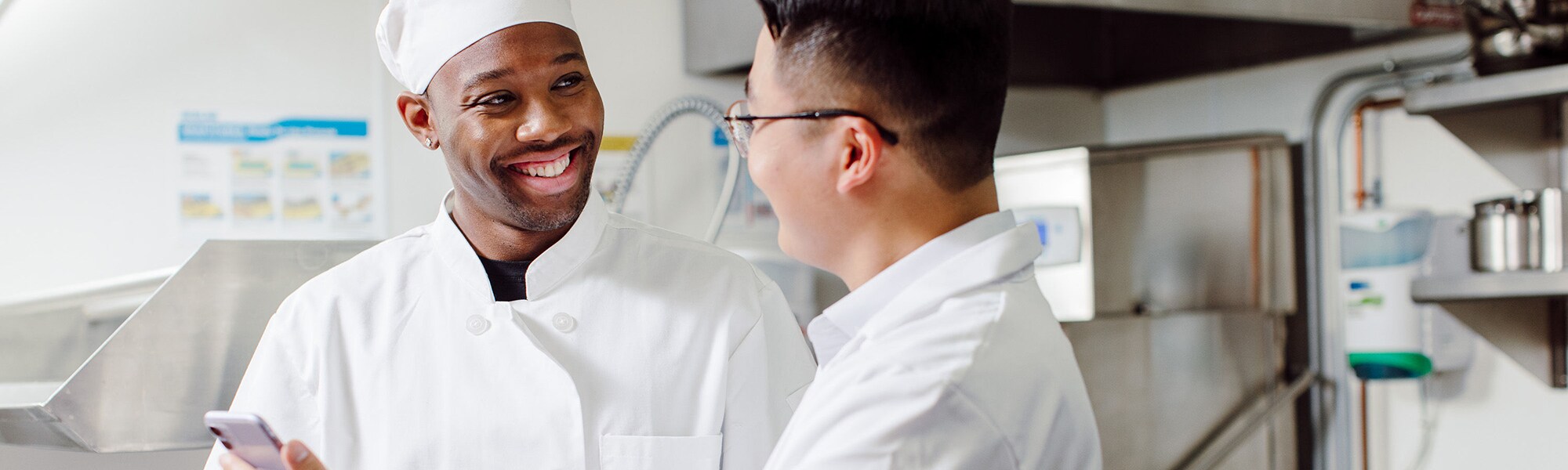 Chef and Ecolab Expert looking at a smart phone
