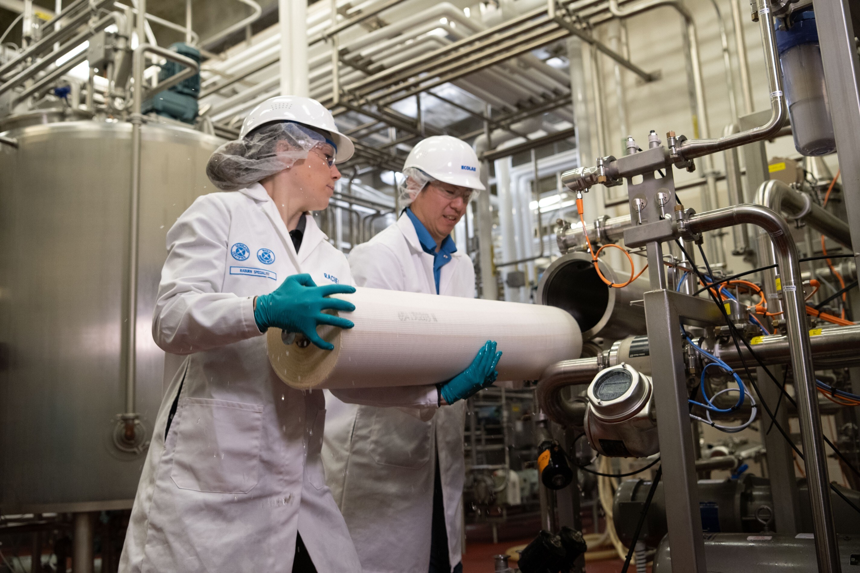An installation image with two Ecolab associates holding a membrane filter